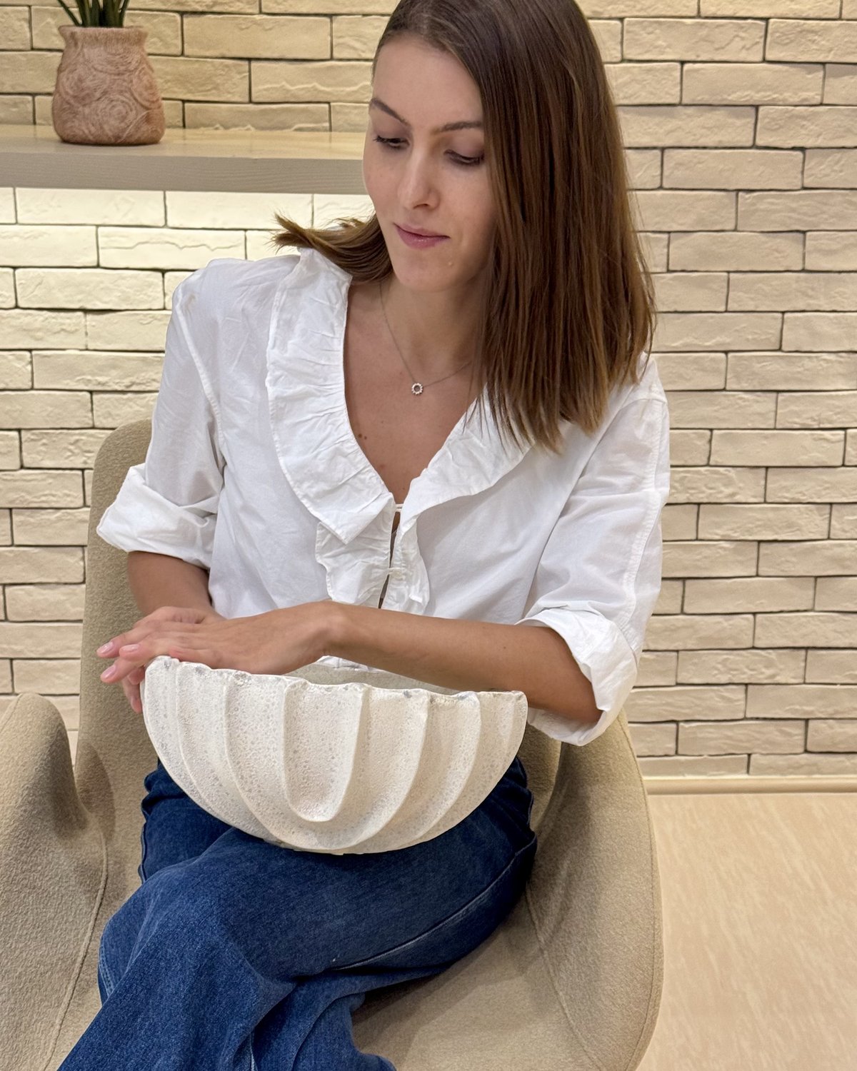 Irina holding a hand-built stoneware bowl
